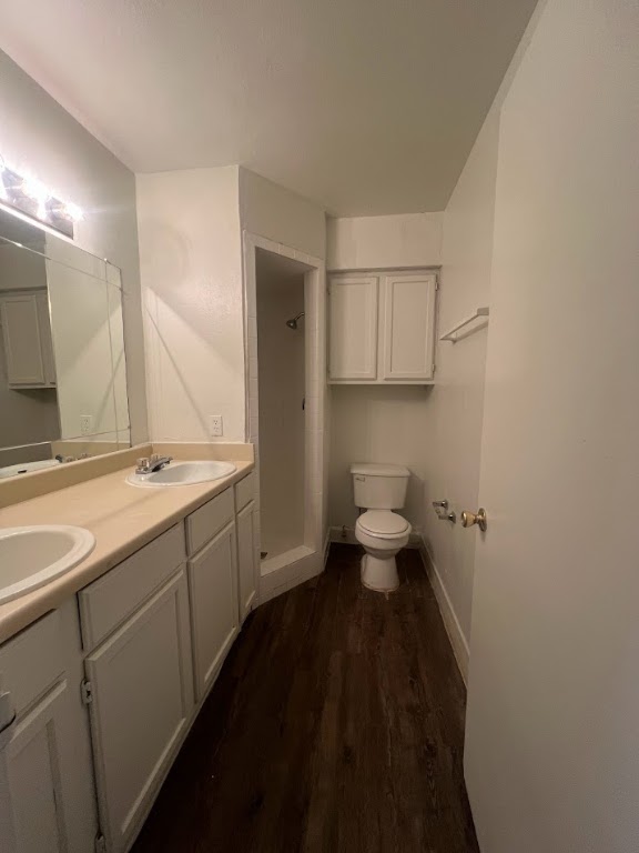 307 East 31st Street, Unit 102 Austin, TX 78705 - Photo 11 of 16 a bathroom with a granite countertop sink a toilet and a large mirror