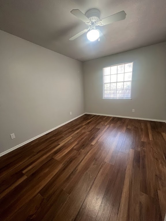 307 East 31st Street, Unit 102 Austin, TX 78705 - Photo 12 of 16 an empty room with wooden floor chandelier fan and windows