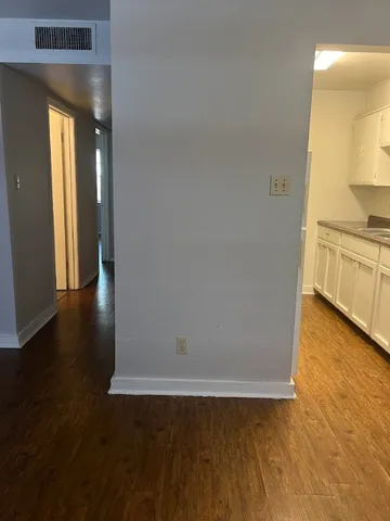 a view of a kitchen with wooden floor and a sink
