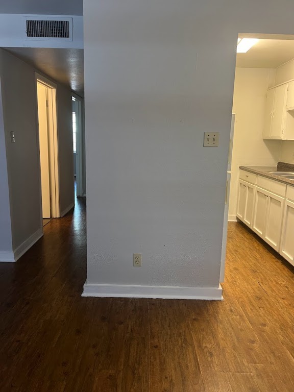 307 East 31st Street, Unit 102 Austin, TX 78705 - Photo 7 of 16 a view of a kitchen with wooden floor and a sink