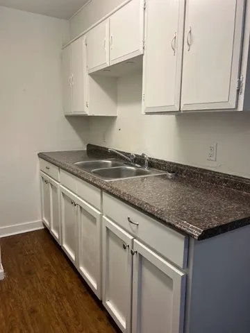 a kitchen with granite countertop white cabinets and a stainless steel appliances