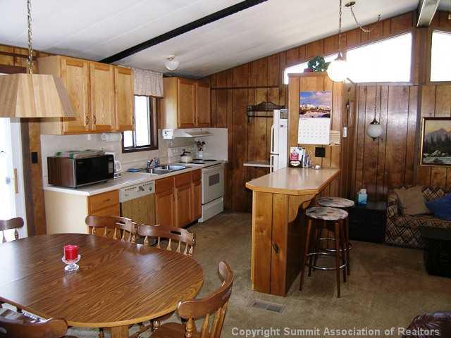 63 Reiling Road Breckenridge, CO 80424 - Photo 5 of 7 a kitchen with sink refrigerator dining table and chairs