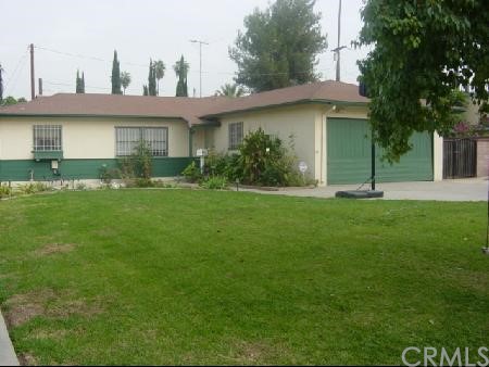 3431 Sidney Street Riverside, CA 92503 - Photo 1 of 1 a view of a white house with a big yard and potted plants and large trees