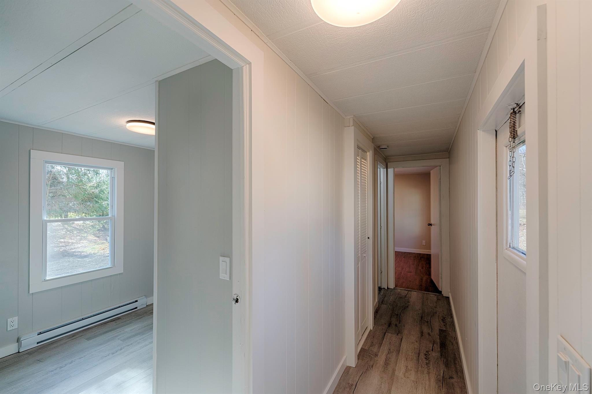 193 Decker Road Stanfordville, NY 12581 - Photo 14 of 34 a view of a hallway with wooden floor and a bathroom