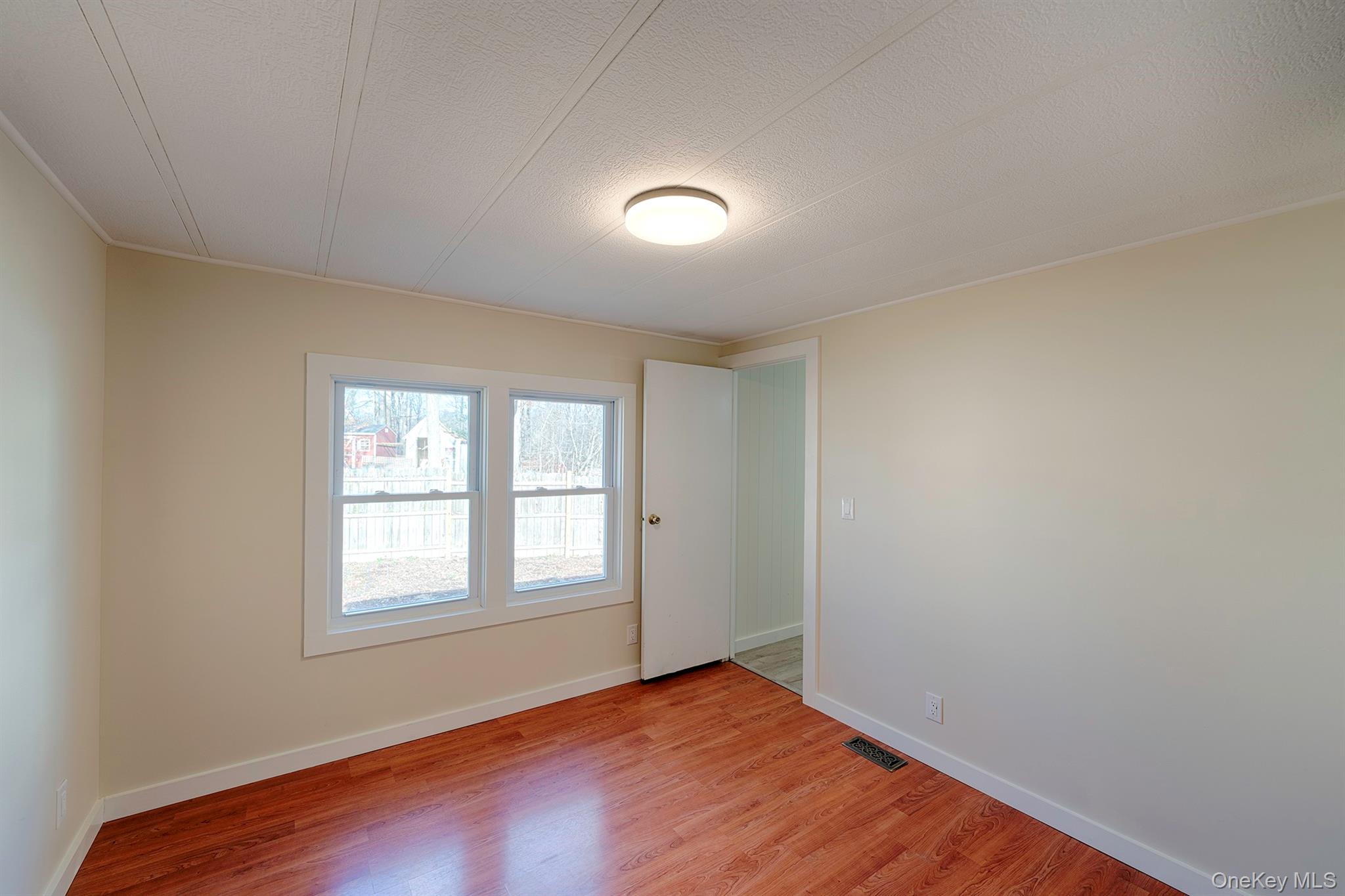 193 Decker Road Stanfordville, NY 12581 - Photo 19 of 34 an empty room with wooden floor and windows