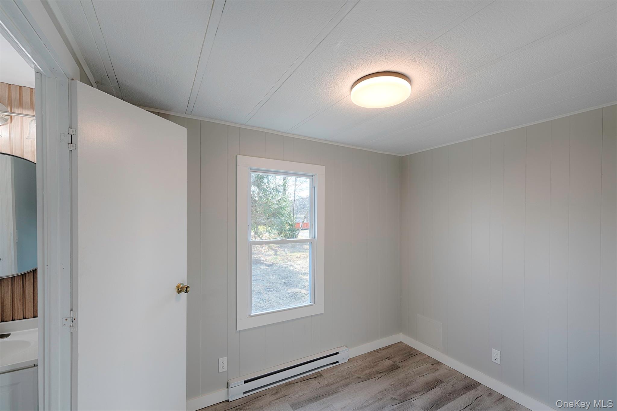 193 Decker Road Stanfordville, NY 12581 - Photo 20 of 34 an empty room with wooden floor and windows