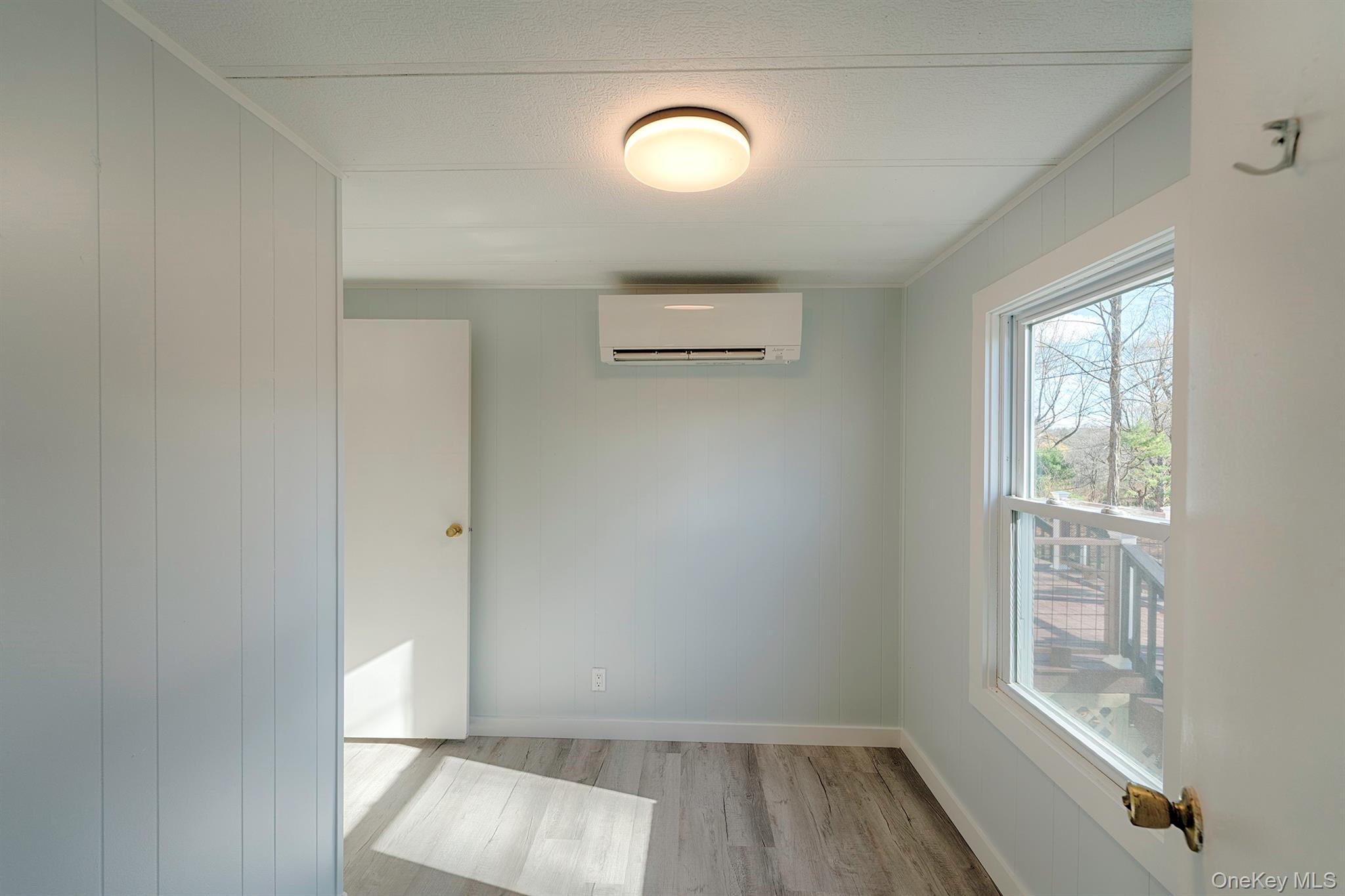 193 Decker Road Stanfordville, NY 12581 - Photo 24 of 34 an empty room with wooden floor and windows