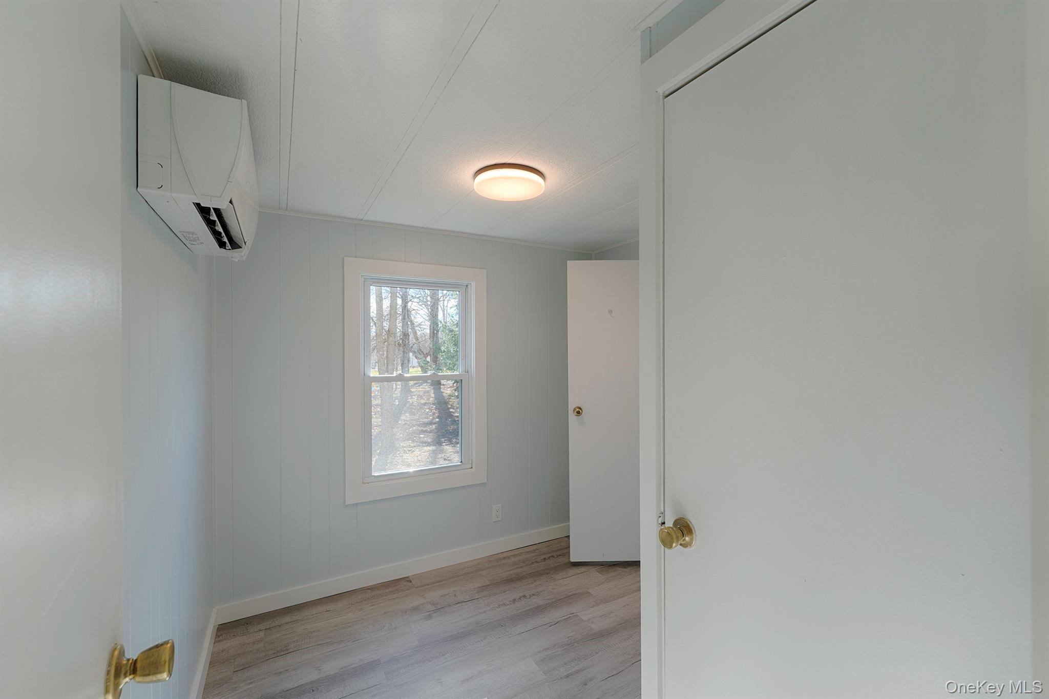 193 Decker Road Stanfordville, NY 12581 - Photo 25 of 34 a view of an empty room with wooden floor and a window