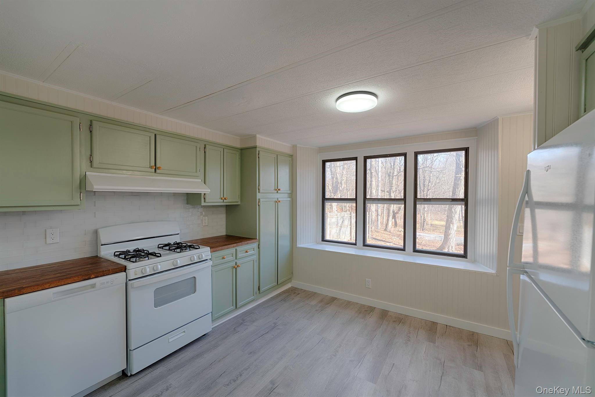 193 Decker Road Stanfordville, NY 12581 - Photo 7 of 34 a kitchen with granite countertop white cabinets and white appliances