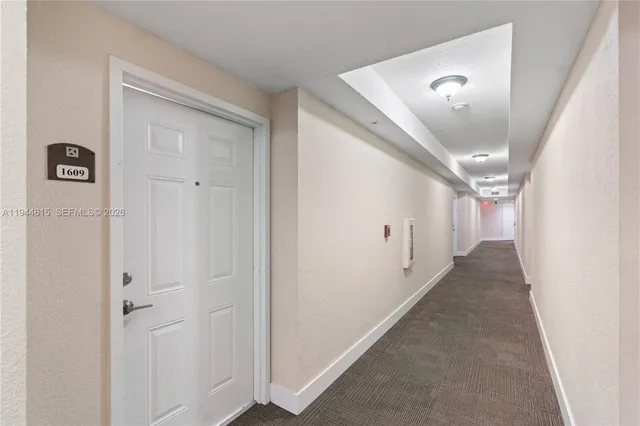 a view of a hallway to a bedroom