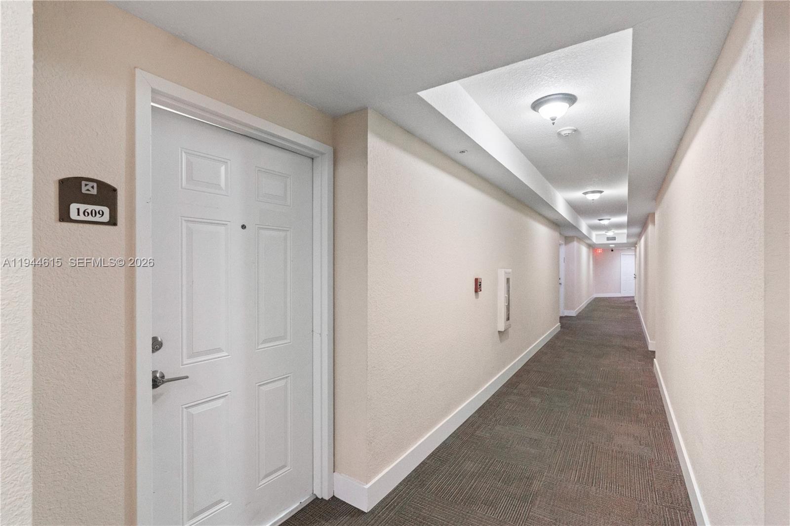 4242 Northwest 2nd Street, Unit 1609 Miami, FL 33126 - Photo 15 of 40 a view of a hallway to a bedroom