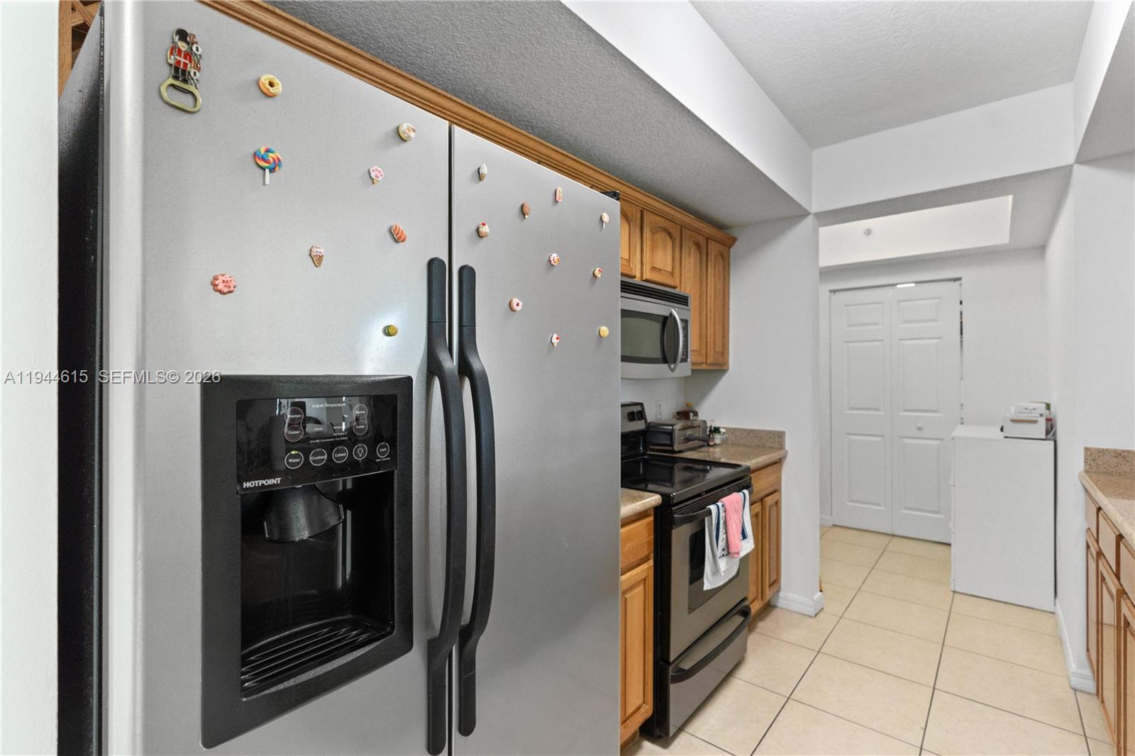 4242 Northwest 2nd Street, Unit 1609 Miami, FL 33126 - Photo 23 of 40 a kitchen with stainless steel appliances granite countertop a refrigerator and a stove