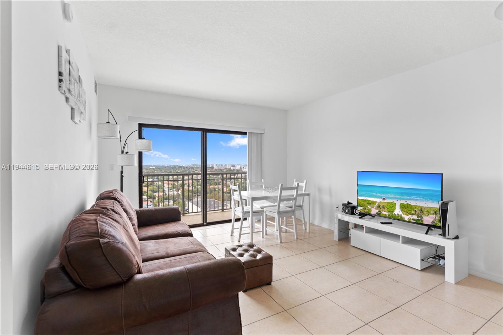 4242 Northwest 2nd Street, Unit 1609 Miami, FL 33126 - Photo 26 of 40 a living room with furniture and a flat screen tv