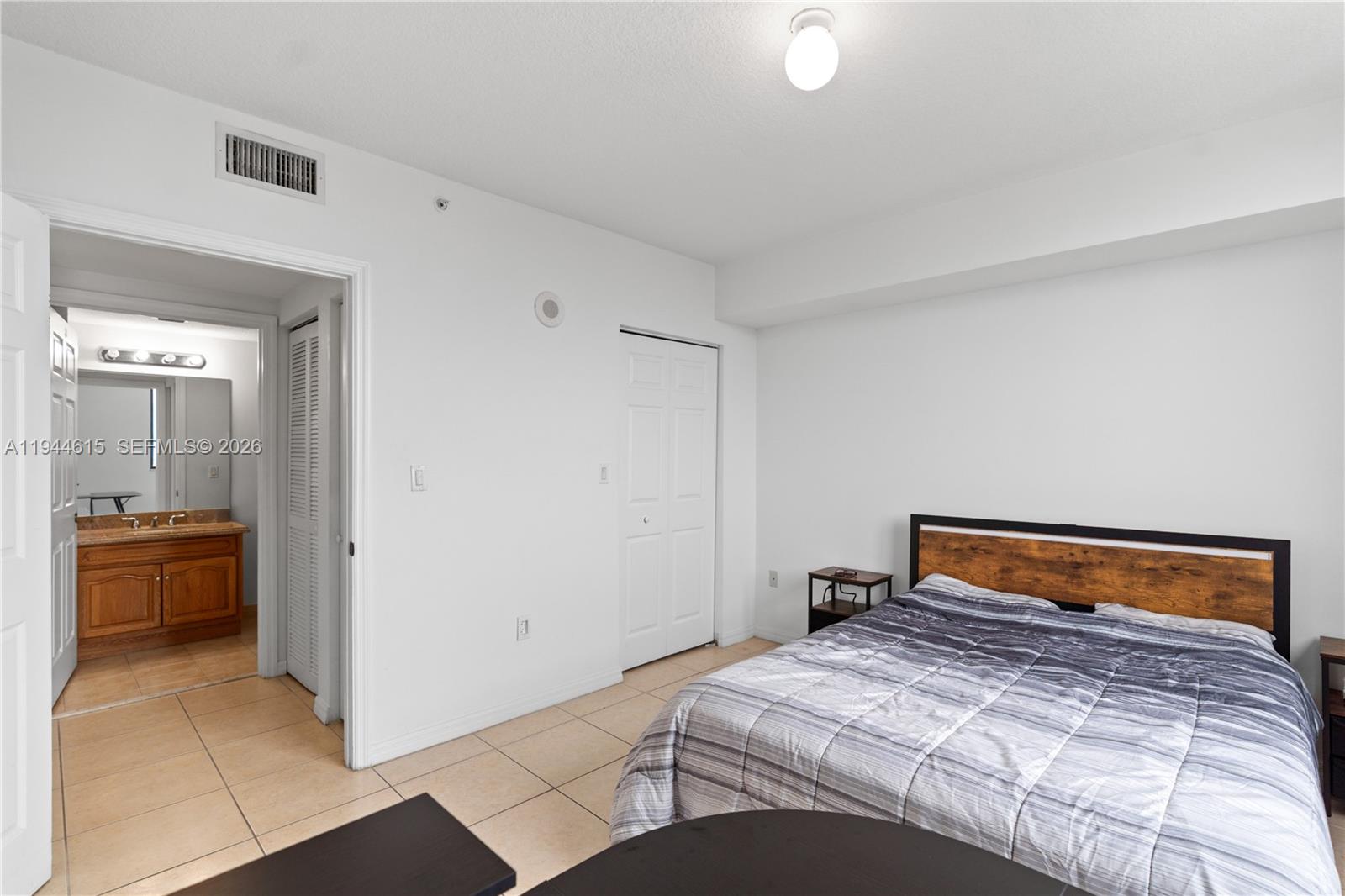 4242 Northwest 2nd Street, Unit 1609 Miami, FL 33126 - Photo 31 of 40 a bedroom with a bed and view of living room