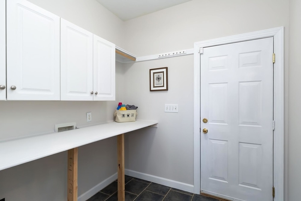 4401 Irene Way Raleigh, NC 27603 - Photo 11 of 30 Laundry Room with cabinet storage and folding table. Laundry