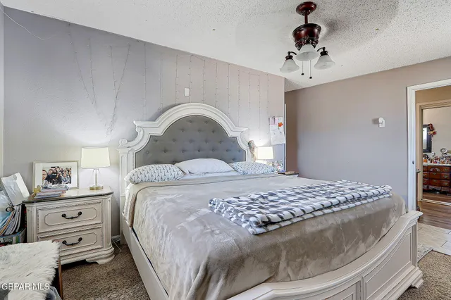 a bedroom with a bed and ceiling fan