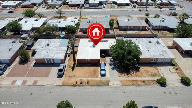 an aerial view of a house with a yard