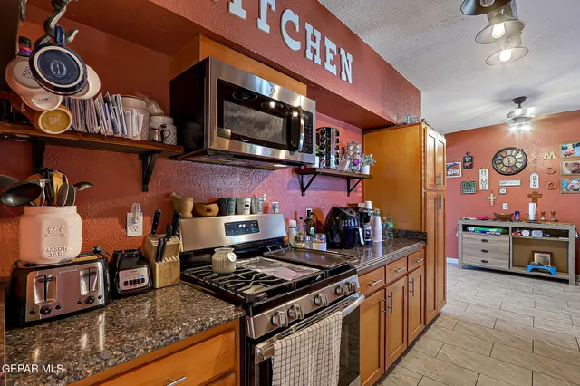 a kitchen with lots of counter top space and stove top oven