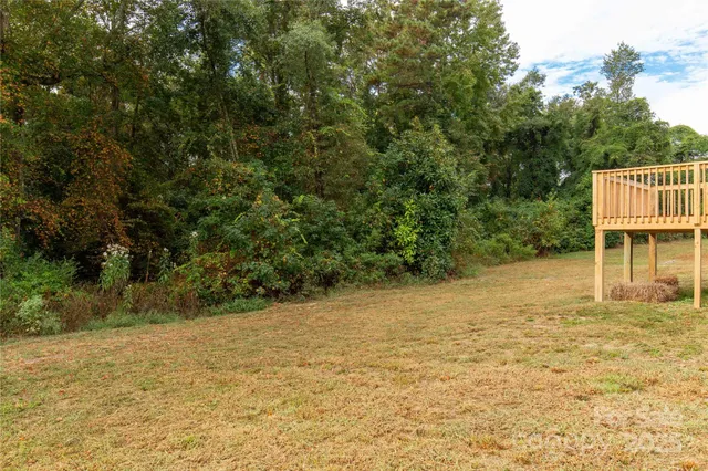 a backyard of a house with large trees