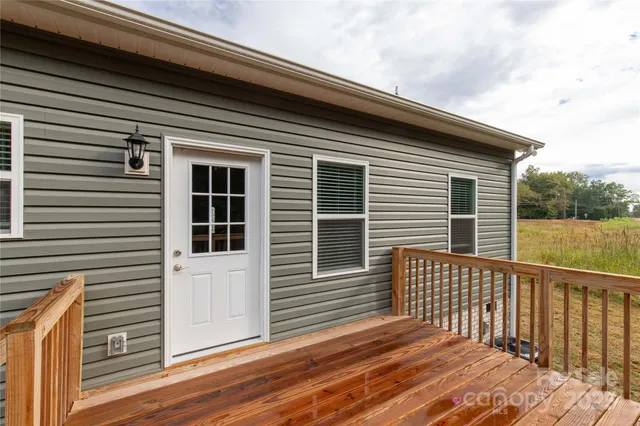 a view of a house with wooden deck