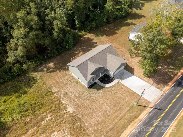 a view of a yard with wooden fence