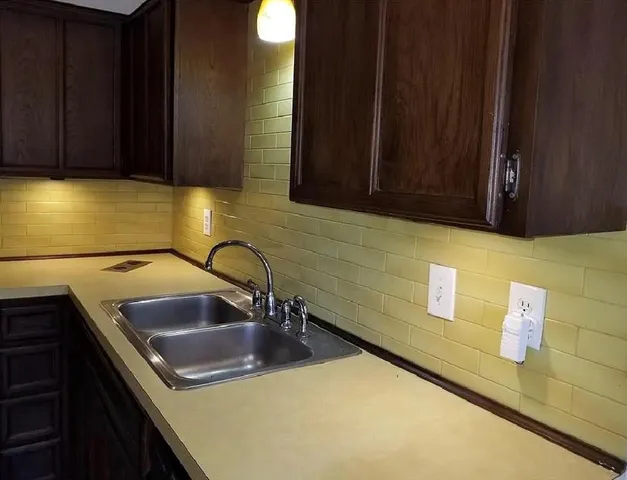 a kitchen with a sink and cabinets