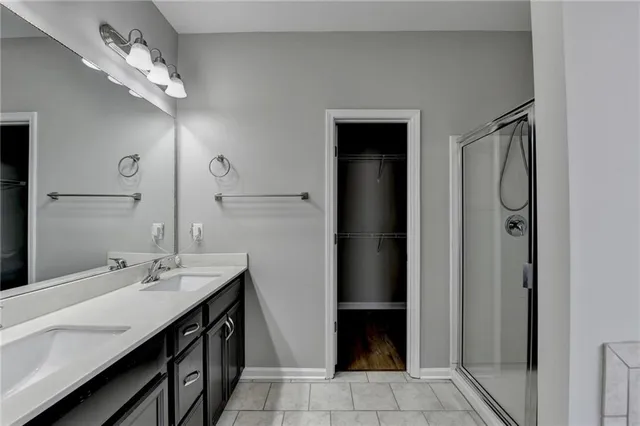 a bathroom with a double vanity sink and a mirror