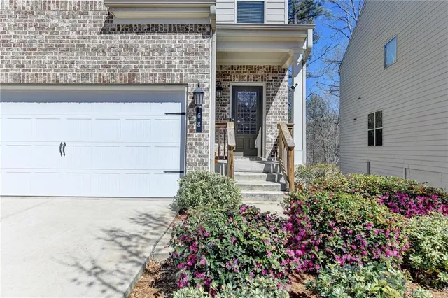 a view of a house with potted plants