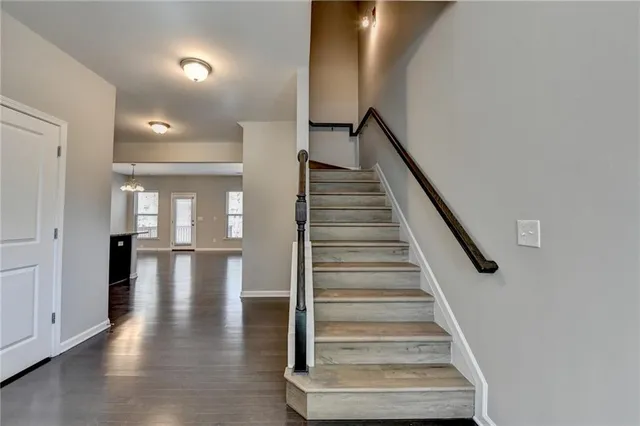 a view of entryway and hall with wooden floor