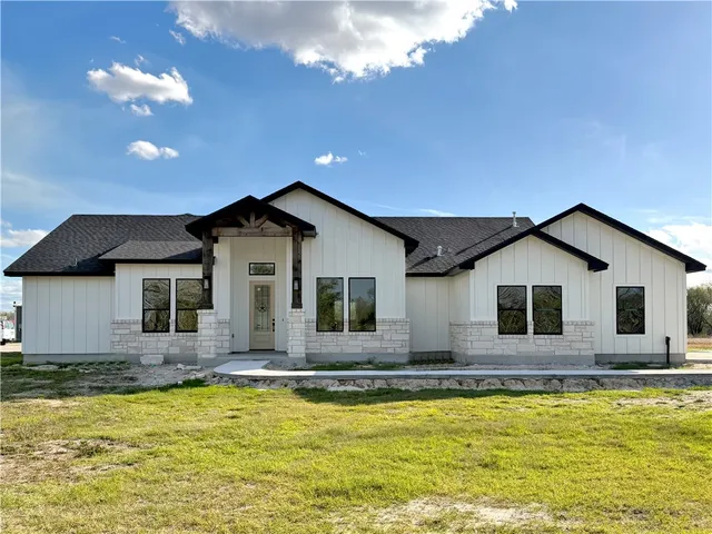 a front view of house with yard and swimming pool