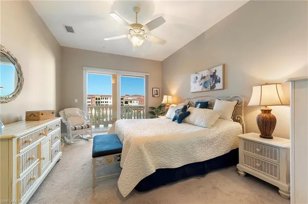 a bedroom with a bed a couch and dresser