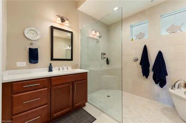 a bathroom with a tub sink and mirror