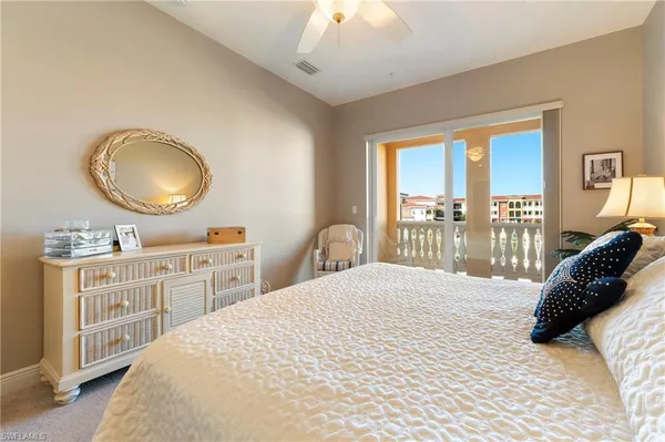 a bedroom with a large bed and a large window