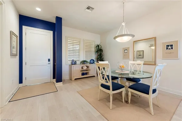 a view of a dining room with furniture and window