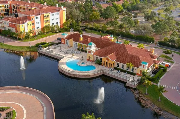 an aerial view of a house with swimming pool and outdoor seating