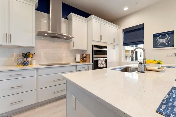 a kitchen with stainless steel appliances a sink and a stove top oven