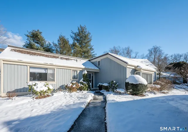 a front view of house with yard outdoor seating and plants