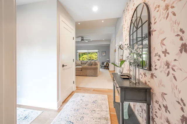 a large kitchen with granite countertop a large center island a sink stainless steel appliances and cabinets