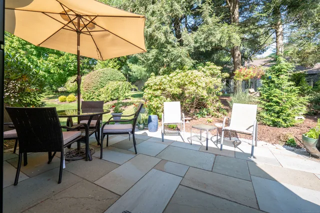 a balcony with table and chairs