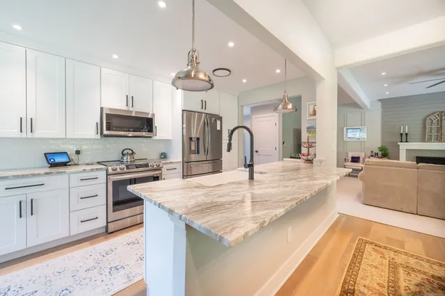 a kitchen with stainless steel appliances granite countertop a stove oven and a refrigerator