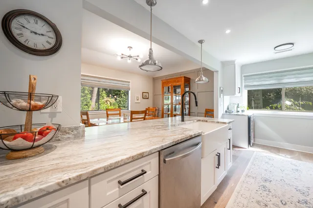 a living room with furniture a fireplace and a large window