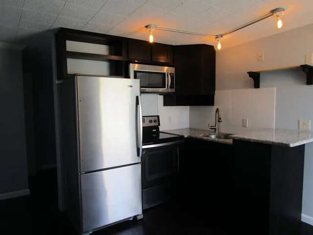 a white refrigerator freezer sitting in a kitchen