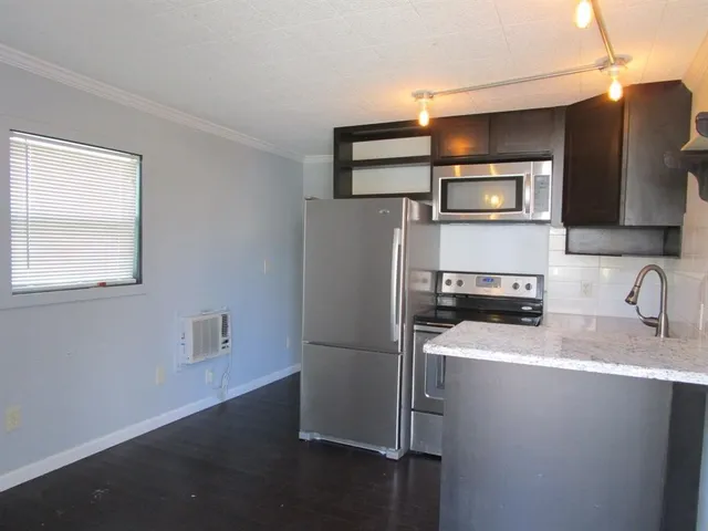 a metallic refrigerator freezer sitting in a kitchen