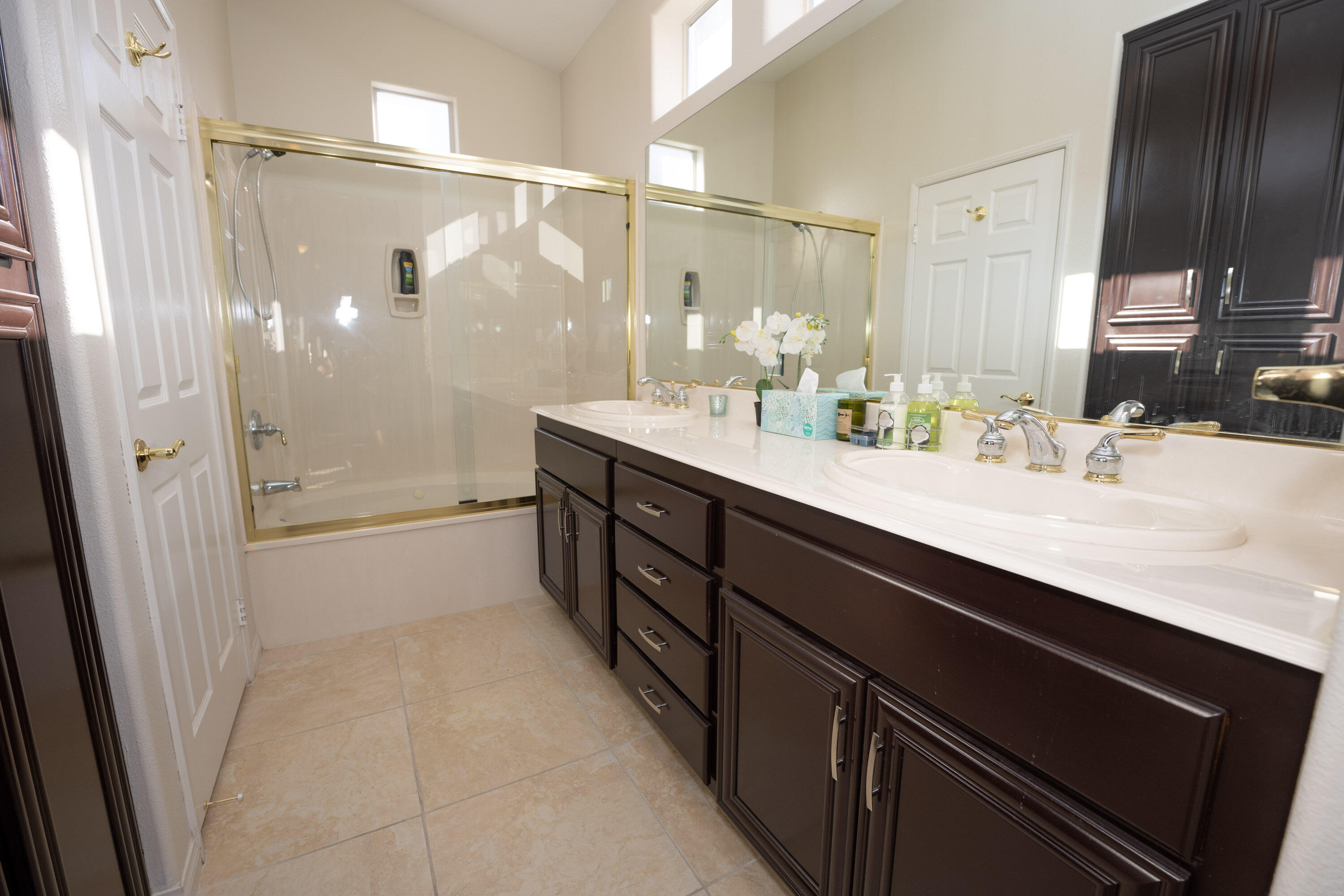 79754 Carmel Valley Avenue Indio, CA 92201 - Photo 12 of 36 a bathroom with a double vanity sink a toilet and a shower