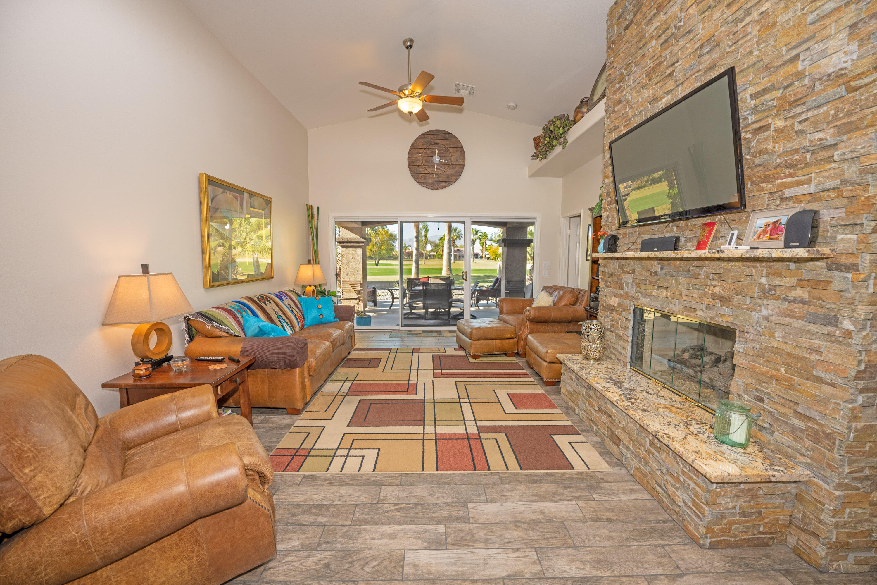 79754 Carmel Valley Avenue Indio, CA 92201 - Photo 14 of 36 a living room with fireplace furniture and a flat screen tv