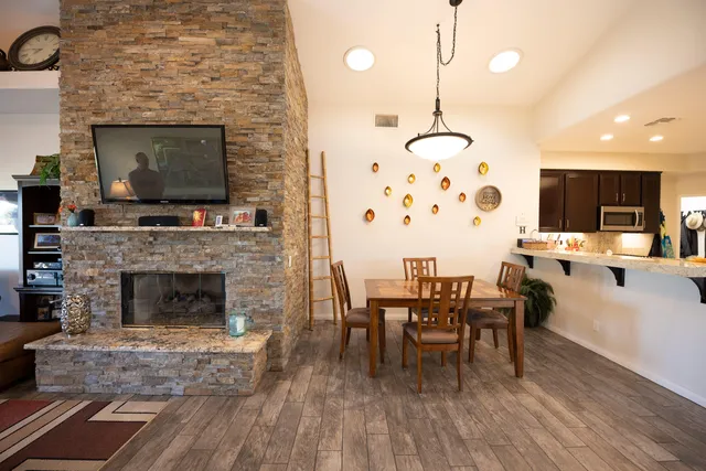 a living room with furniture a fireplace and a flat screen tv