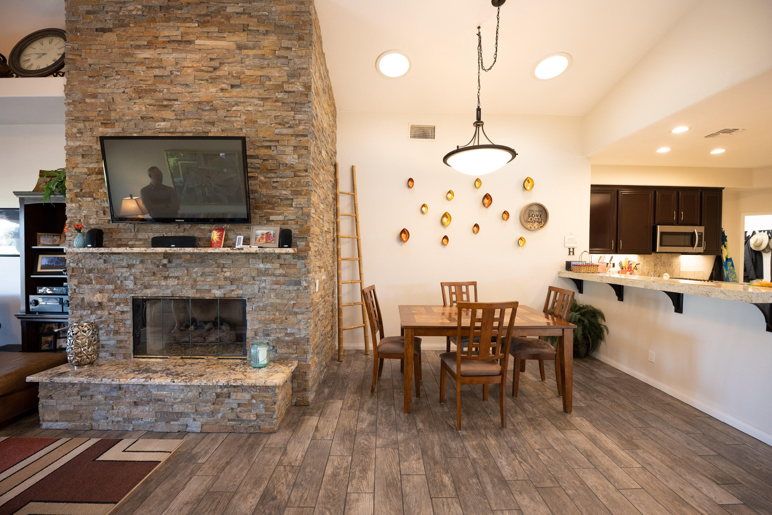 79754 Carmel Valley Avenue Indio, CA 92201 - Photo 17 of 36 a living room with furniture a fireplace and a flat screen tv