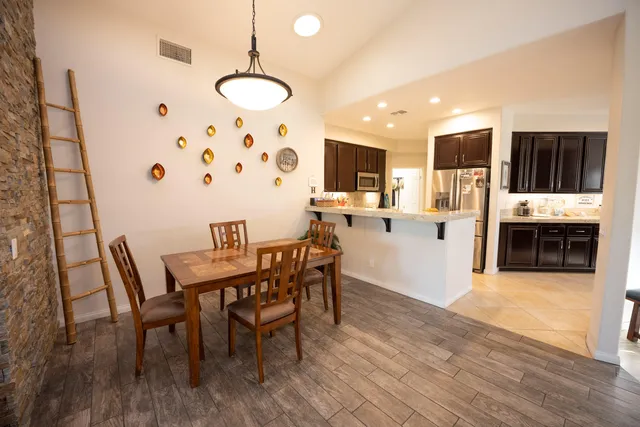 a view of a dining room with furniture and wooden floor