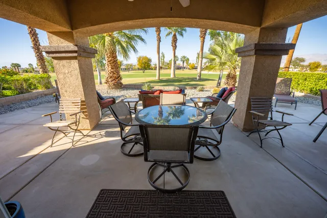 a view of a porch with furniture and garden
