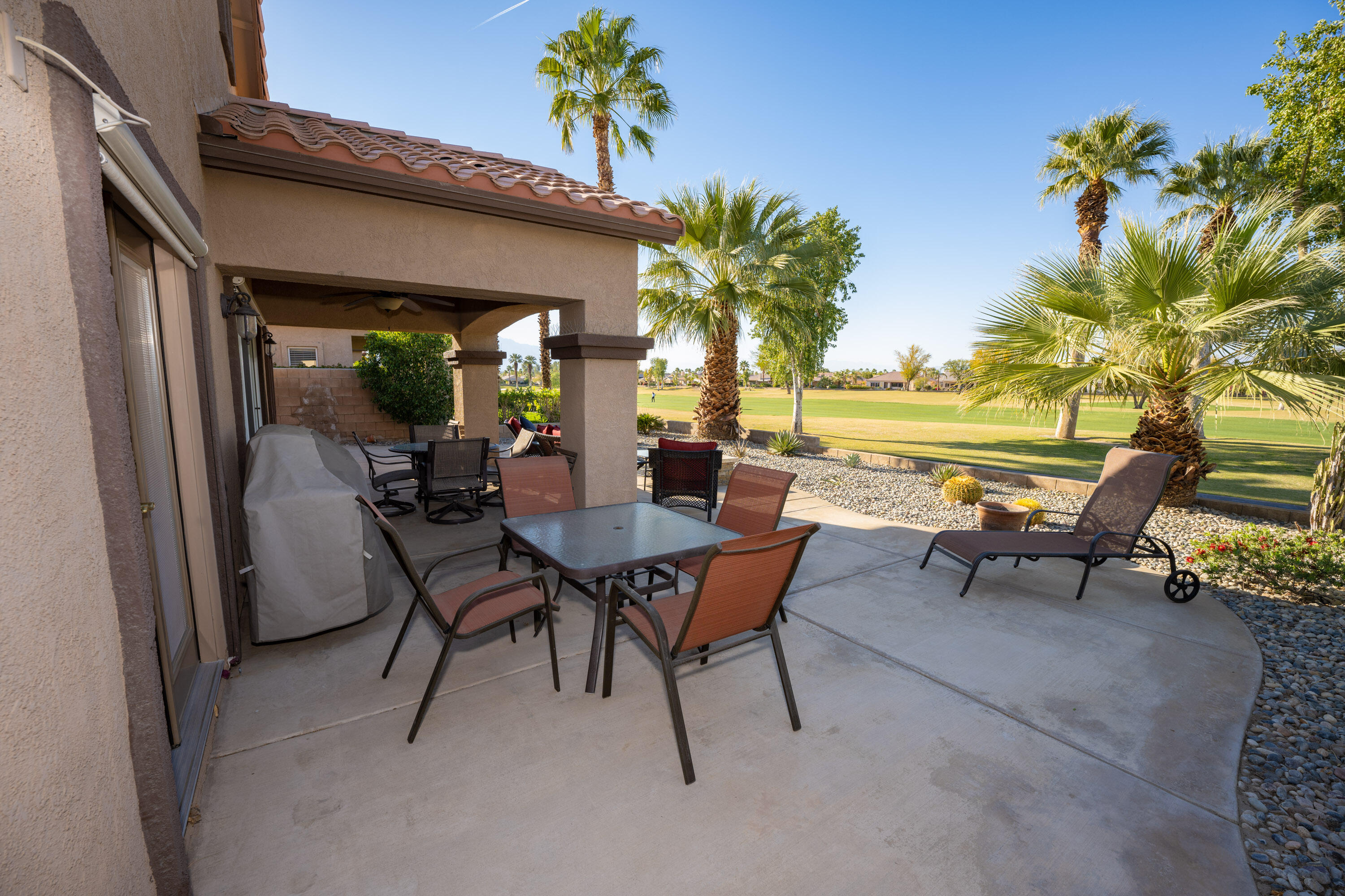 79754 Carmel Valley Avenue Indio, CA 92201 - Photo 22 of 36 a view of a patio with a table and chairs